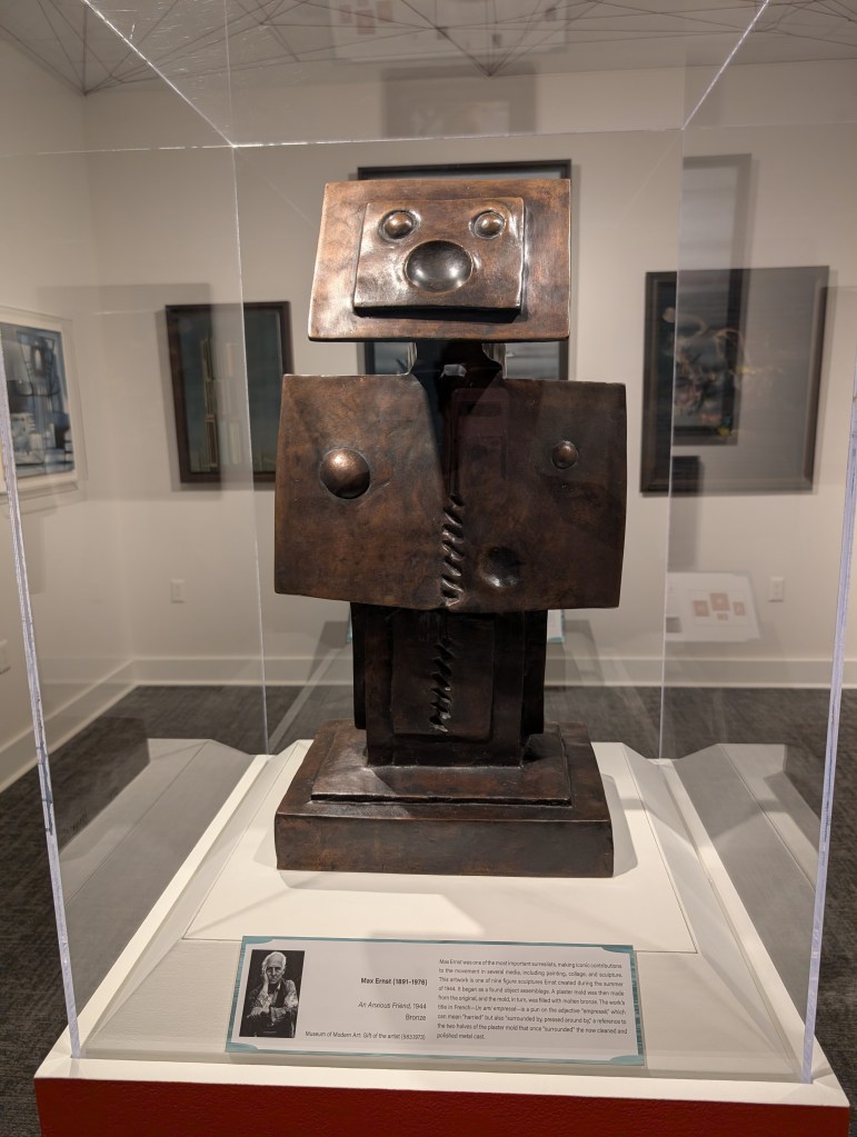 A metal sculpture that looks like a little armless robot giving a little yell.