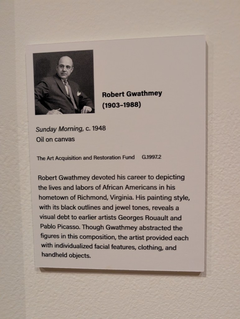A plaque that says the art is called "Sunday Morning" and was made in 1948 by Robert Gwathmey