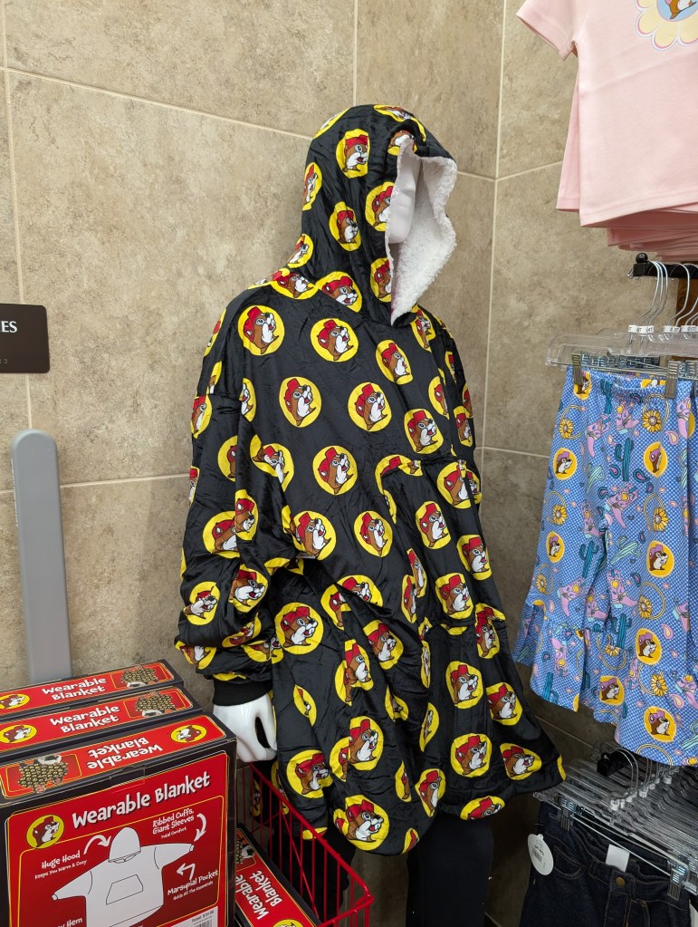 A wearable blanket with the Bucc-ee's logo all over it.