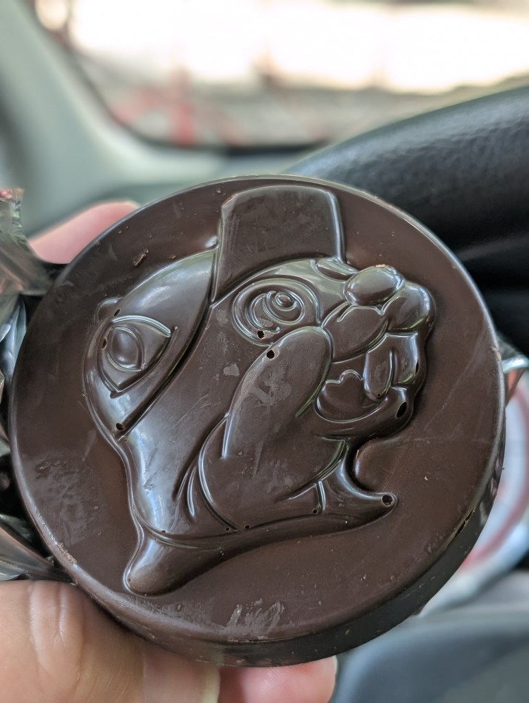 A large medallion of dark chocolate with the Bucc-ee's head on the top.